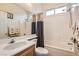 Bathroom featuring tub/shower combo, large mirror, and vanity with sink and toilet at 1252 N Sloan Ln, Las Vegas, NV 89110