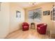 Office area featuring two red chairs, bamboo floors and a large bright window at 1252 N Sloan Ln, Las Vegas, NV 89110