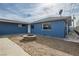 Backyard featuring gravel landscaping, a fire pit, a satellite dish, and a blue exterior wall at 143 Constitution Ave, Henderson, NV 89015
