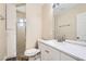 Bright bathroom featuring a shower, toilet, and a vanity with a sink and a large mirror at 143 Constitution Ave, Henderson, NV 89015