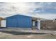 Large garage with double doors and side access gate to backyard with exterior painted blue at 143 Constitution Ave, Henderson, NV 89015