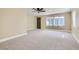 Bright and airy living room featuring neutral carpet, ceiling fan, and large window at 143 Constitution Ave, Henderson, NV 89015
