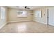 Spacious open-concept living room with tile flooring, built-in shelving, and natural light at 143 Constitution Ave, Henderson, NV 89015