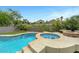 Landscaped backyard featuring a pool, spa, fire pit, and an outdoor lounge area for relaxation and entertainment at 1547 Harwood Ave, Henderson, NV 89012