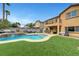 Backyard oasis with a pool, spa, lounge area, and lush landscaping, perfect for outdoor gatherings at 1547 Harwood Ave, Henderson, NV 89012