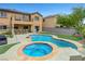 Backyard oasis featuring a pool, spa, patio area, and a well-maintained lawn for outdoor enjoyment at 1547 Harwood Ave, Henderson, NV 89012