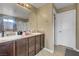 Elegant bathroom featuring double sinks, a large vanity, and a shower at 1547 Harwood Ave, Henderson, NV 89012