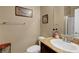 Bathroom featuring a single sink with a granite countertop and framed art at 1547 Harwood Ave, Henderson, NV 89012