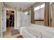 Luxurious bathroom with a soaking tub, walk-in shower, and closet at 1547 Harwood Ave, Henderson, NV 89012