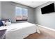 Cozy bedroom with a large window providing natural light and a wall-mounted TV at 1547 Harwood Ave, Henderson, NV 89012