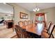 Elegant dining room featuring a large wooden table, seating for eight, and warm lighting at 1547 Harwood Ave, Henderson, NV 89012