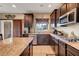 Gourmet kitchen boasts granite counters, stainless appliances, and dark wood cabinets at 1547 Harwood Ave, Henderson, NV 89012
