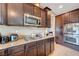 Gourmet kitchen includes modern appliances, granite counters, and dark wood cabinets at 1547 Harwood Ave, Henderson, NV 89012