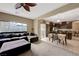 Open living space with plush sectional sofa, adjacent to the kitchen with dark wood cabinets at 1547 Harwood Ave, Henderson, NV 89012