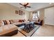 Spacious living room featuring a plush sectional sofa, ceiling fan and neutral-toned walls at 1547 Harwood Ave, Henderson, NV 89012