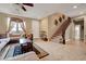 Inviting living room featuring a comfortable sofa and access to an elegant staircase at 1547 Harwood Ave, Henderson, NV 89012