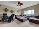 Comfortable living room with a large sectional sofa, ceiling fan, and natural light from the windows at 1547 Harwood Ave, Henderson, NV 89012