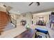 Spacious living room with tile flooring, featuring a carpeted staircase and dining area at 1547 Harwood Ave, Henderson, NV 89012