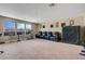 Carpeted living room with large window, bar seating, and movie chairs in the home at 1547 Harwood Ave, Henderson, NV 89012