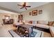 Open-concept living area with comfortable seating, tile floors, and access to the dining area at 1547 Harwood Ave, Henderson, NV 89012
