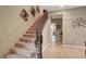 Carpeted staircase with decorative wrought iron railing leads to the upper level of the home at 1547 Harwood Ave, Henderson, NV 89012