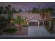 Stunning aerial view of the home showcasing its lush landscaping, three-car garage, and tile roof at 1624 Preston Park Dr, Henderson, NV 89052