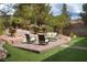 Inviting backyard patio with comfortable seating and lush landscaping creates a relaxing outdoor oasis at 1624 Preston Park Dr, Henderson, NV 89052