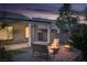 Relaxing backyard patio with a fire pit, comfortable seating, and views of the home's architecture at 1624 Preston Park Dr, Henderson, NV 89052