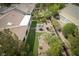 Aerial view of a landscaped backyard with a manicured lawn, a patio area, and lush garden beds at 1624 Preston Park Dr, Henderson, NV 89052