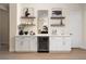 Stylish bar area featuring a wine refrigerator, floating shelves, and elegant decor at 1624 Preston Park Dr, Henderson, NV 89052