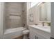 Modern bathroom with gray tiled shower/bathtub, white vanity with vessel sink, and lighted mirror at 1624 Preston Park Dr, Henderson, NV 89052