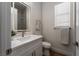 Bright bathroom featuring a vanity with lighted mirror and a shower with glass doors at 1624 Preston Park Dr, Henderson, NV 89052