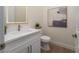 Modern bathroom with a sleek vanity, contemporary fixtures, and a well-lit mirror, plus a comfort height toilet at 1624 Preston Park Dr, Henderson, NV 89052