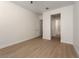 Bedroom with ceiling fan, wood floors, and views to the ensuite bathroom at 1624 Preston Park Dr, Henderson, NV 89052