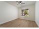 Bright bedroom with ceiling fan, wood floors, and large window offering natural light at 1624 Preston Park Dr, Henderson, NV 89052