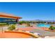 Beautiful view of the community pool with ample lounge chairs and mountain views in the distance at 1624 Preston Park Dr, Henderson, NV 89052