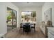 Elegant dining room with a modern chandelier, stylish furniture, and a large window showcasing the backyard at 1624 Preston Park Dr, Henderson, NV 89052