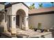 Charming front entrance with a gated courtyard, seating, and stylish architectural details at 1624 Preston Park Dr, Henderson, NV 89052