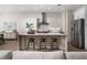 Bright, modern kitchen with stainless steel appliances, a large island, and seating for three at 1624 Preston Park Dr, Henderson, NV 89052