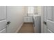 Well-lit laundry room with white cabinets, sink, and modern washer and dryer at 1624 Preston Park Dr, Henderson, NV 89052