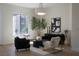 Bright living room with stylish furniture, a modern art piece, and large windows offering views of the outdoors at 1624 Preston Park Dr, Henderson, NV 89052