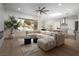 Open living room boasts a large sectional sofa and a view of the beautifully landscaped backyard at 1624 Preston Park Dr, Henderson, NV 89052
