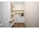 Well-organized pantry with ample shelving, white cabinetry, and a convenient countertop space at 1624 Preston Park Dr, Henderson, NV 89052