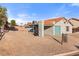View of the home's backyard, showing the concrete driveway, low maintenance landscaping and covered carport at 1775 Esteban Ave, Laughlin, NV 89029