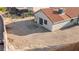 A desert landscaped backyard with an outdoor patio and a back door to enter the house at 1775 Esteban Ave, Laughlin, NV 89029