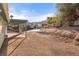 Wide angle view of a backyard with a covered patio and a spacious gravel area at 1775 Esteban Ave, Laughlin, NV 89029
