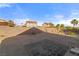 Backyard showcasing desert landscaping, partial perimeter wall, and fencing at 1775 Esteban Ave, Laughlin, NV 89029