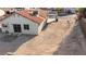 A desert landscaped backyard with an outdoor patio and a back door to enter the house at 1775 Esteban Ave, Laughlin, NV 89029