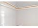 Close-up of an empty closet with wooden hanging rods at 1775 Esteban Ave, Laughlin, NV 89029