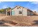 Charming single-story home featuring a teal garage door, tile roof, and low-maintenance desert landscaping at 1775 Esteban Ave, Laughlin, NV 89029